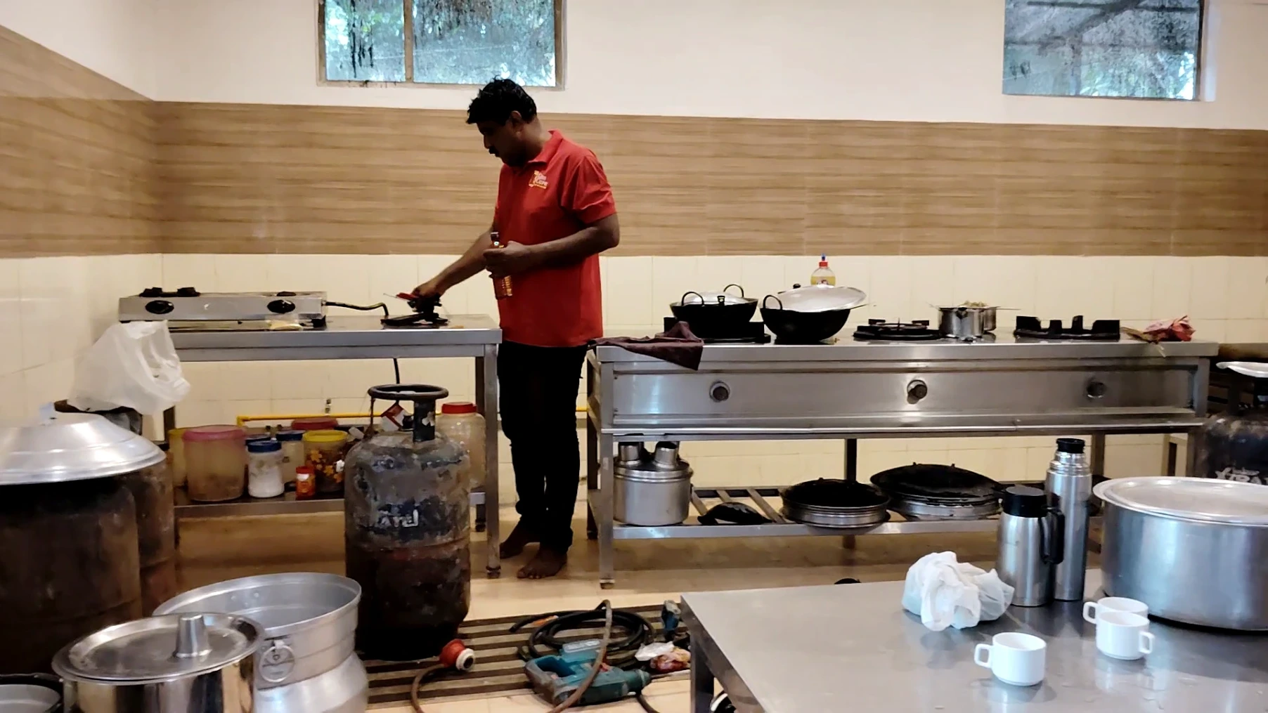 A Gas Care professional inspects the pipeline installation position in a commercial kitchen while installing an LPG pipeline
