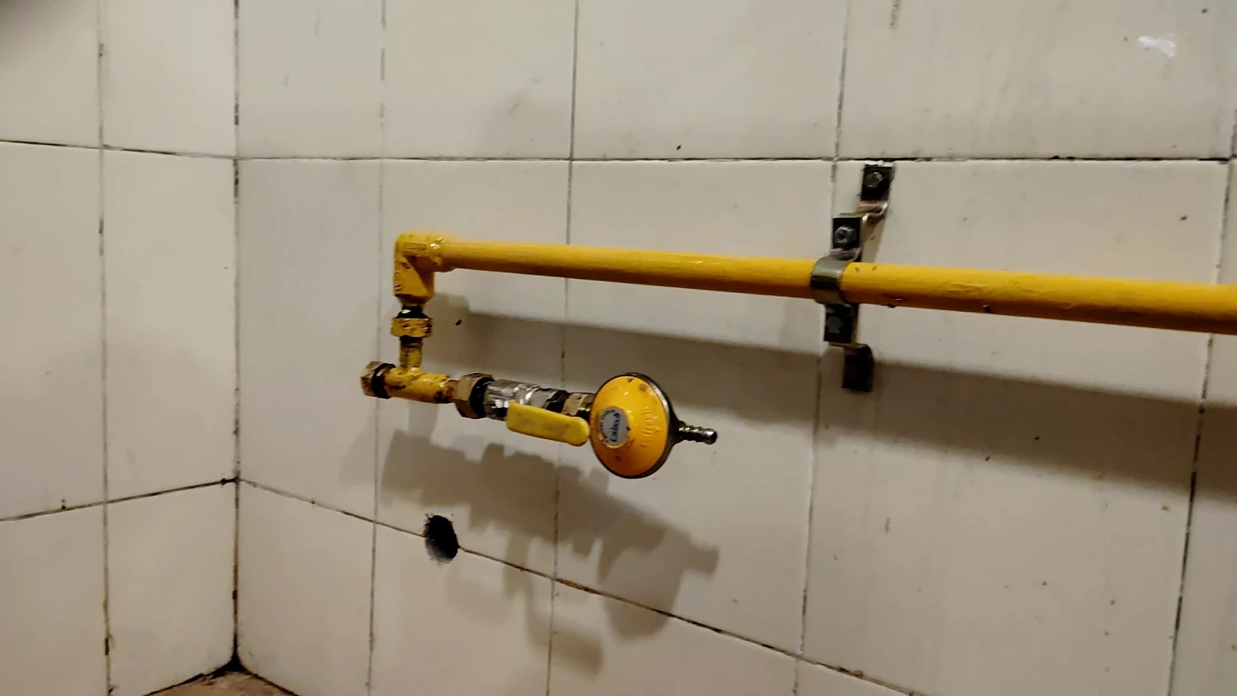 A high-pressure to low-pressure conversion regulator installed on the main line, allowing for direct connection of both high-pressure burners and low-pressure cooktops.
